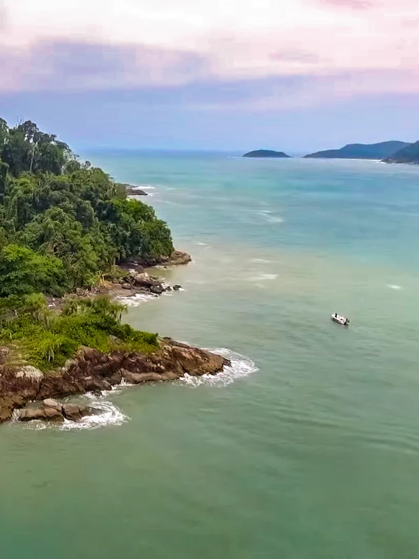 Barco com turistas navegando na Ilha do Guarau em Peruíbe.